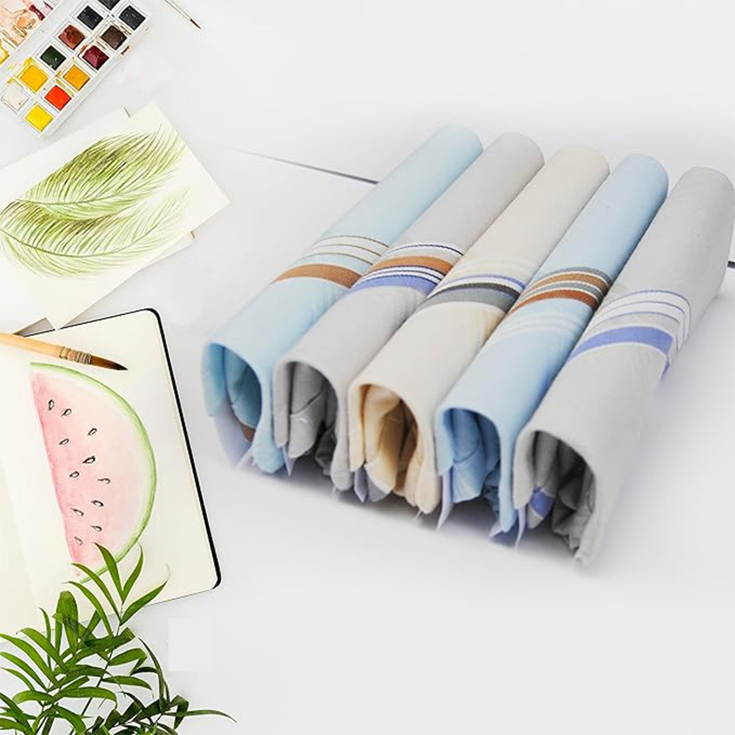 Rolled men's cotton handkerchiefs in assorted soft tones with multicolored striped borders