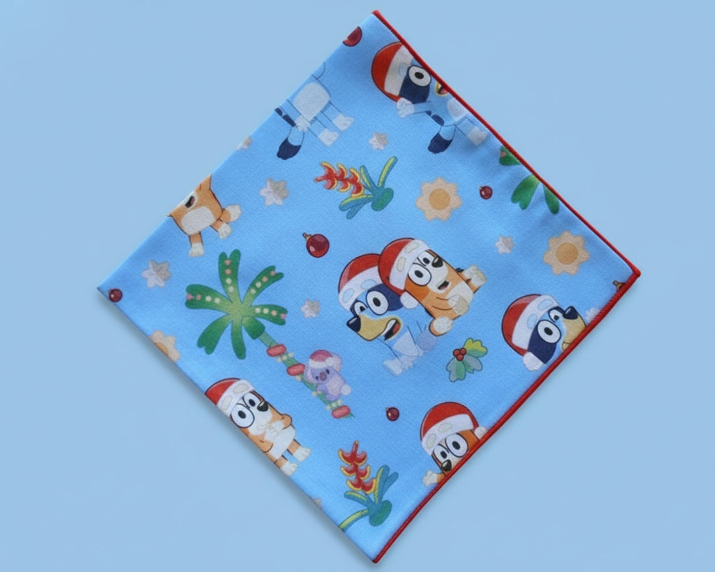 Single blue silky satin kids’ handkerchief featuring a tropical holiday scene with popular animated characters.