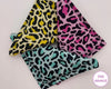 Three colorful hankies with leopard print patterns on a light background, branded 'The Hankie'.