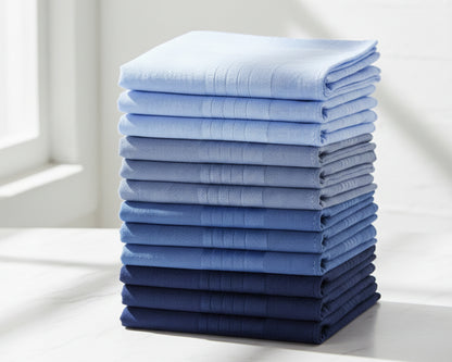 Stack of folded blue towels on a white surface with a light background