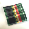 Plaid fabric with green, red, yellow, and black colors on a white background