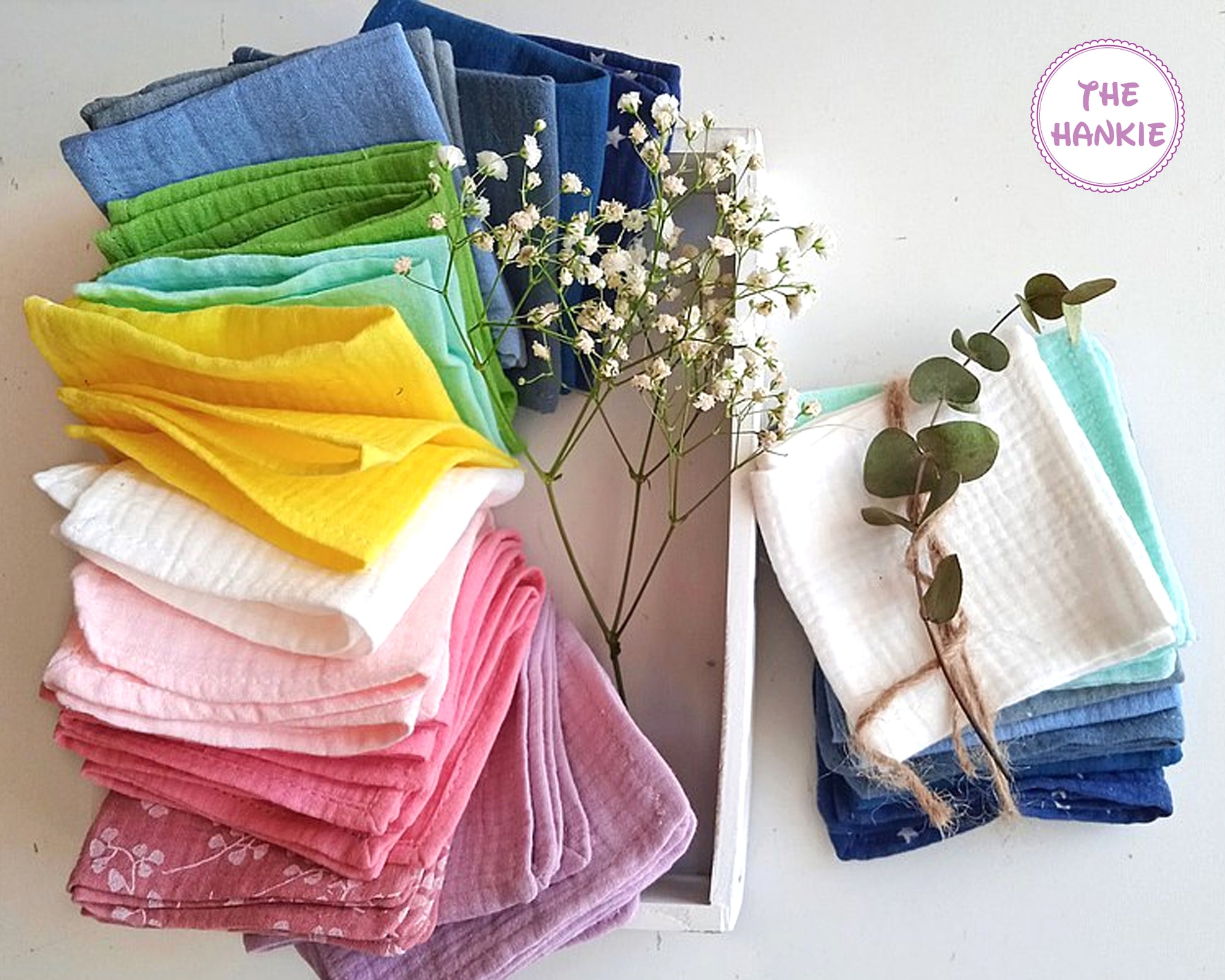 Stack of colorful handkerchiefs with decorative elements on a white background