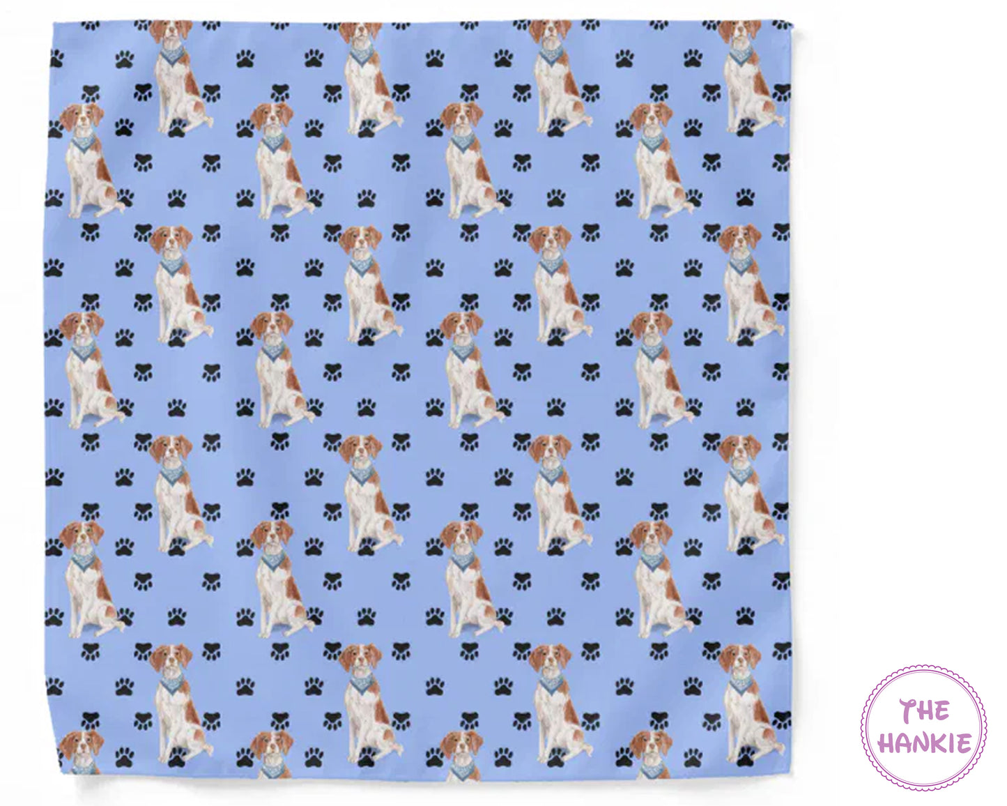 Patterned fabric with dogs and paw prints on a blue background, featuring 'The Hankie' brand.