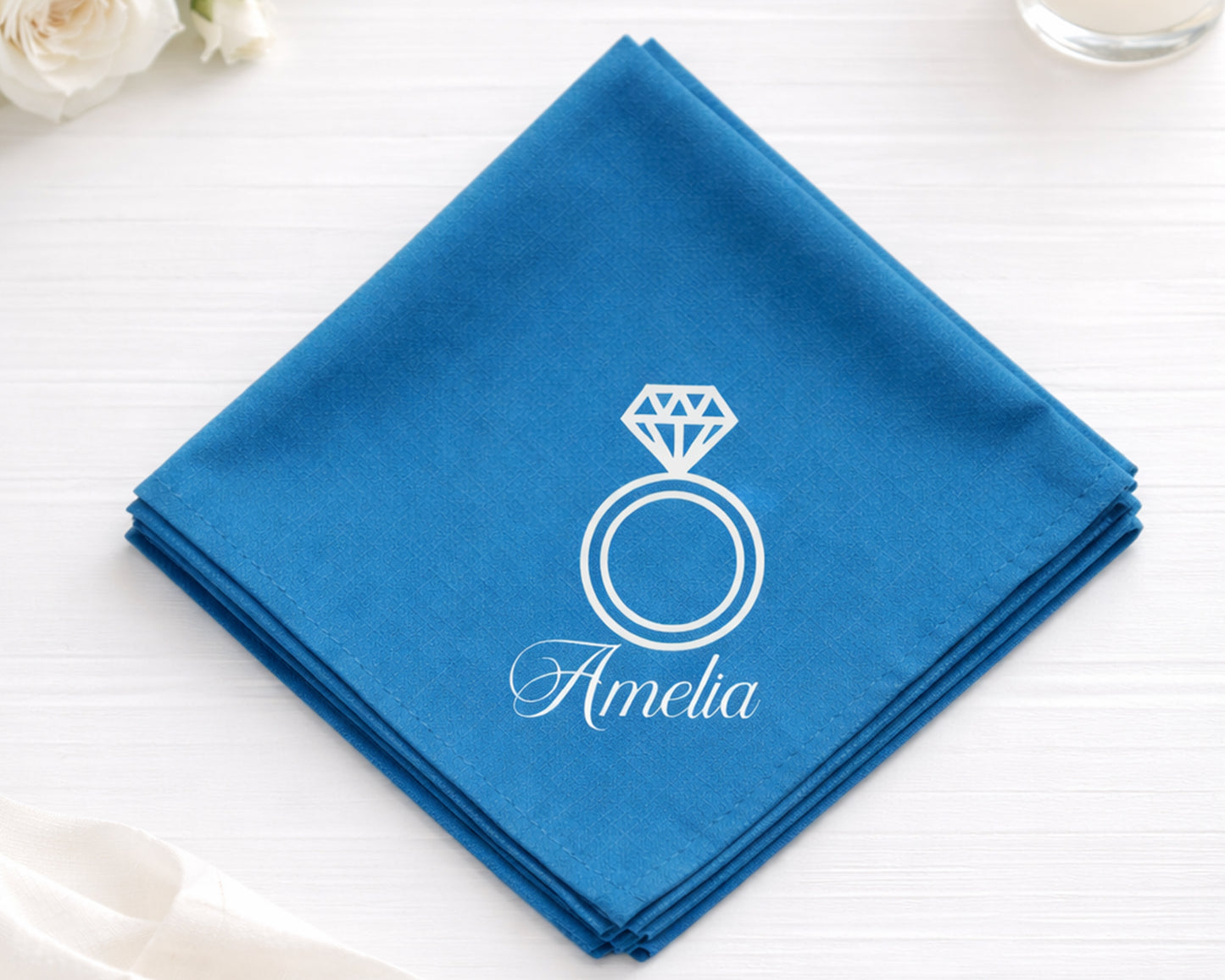 Blue hanky with a diamond ring design and 'Amelia' text on a white surface.