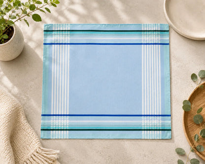 Blue plaid placemat on a light surface with decorative elements