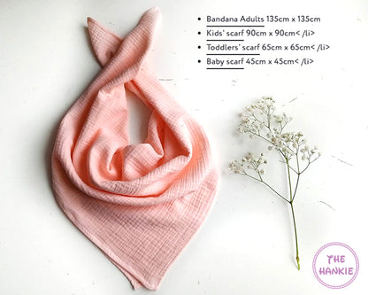 Pink scarf with dimensions listed on a white background