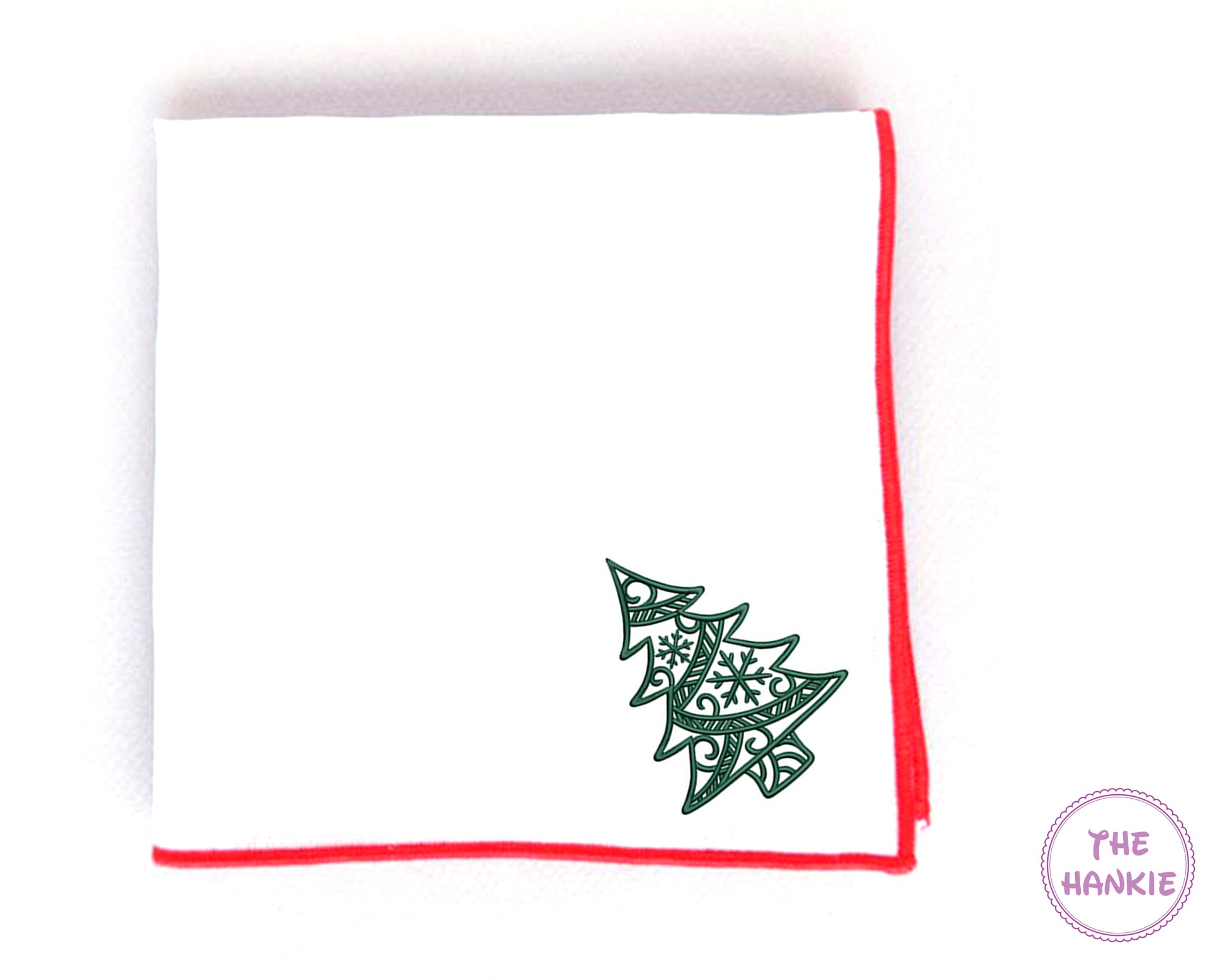 White hankie with green Christmas tree design and red border on a white background