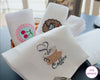 White hankies with embroidered designs on a table, featuring the brand 'The Hankie'.