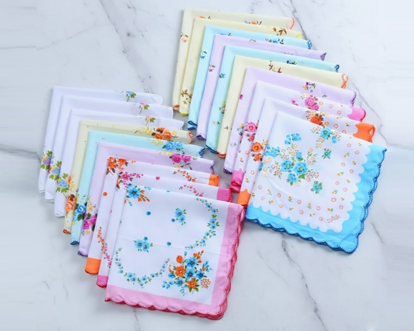 Collection of colorful floral handkerchiefs on a marble surface