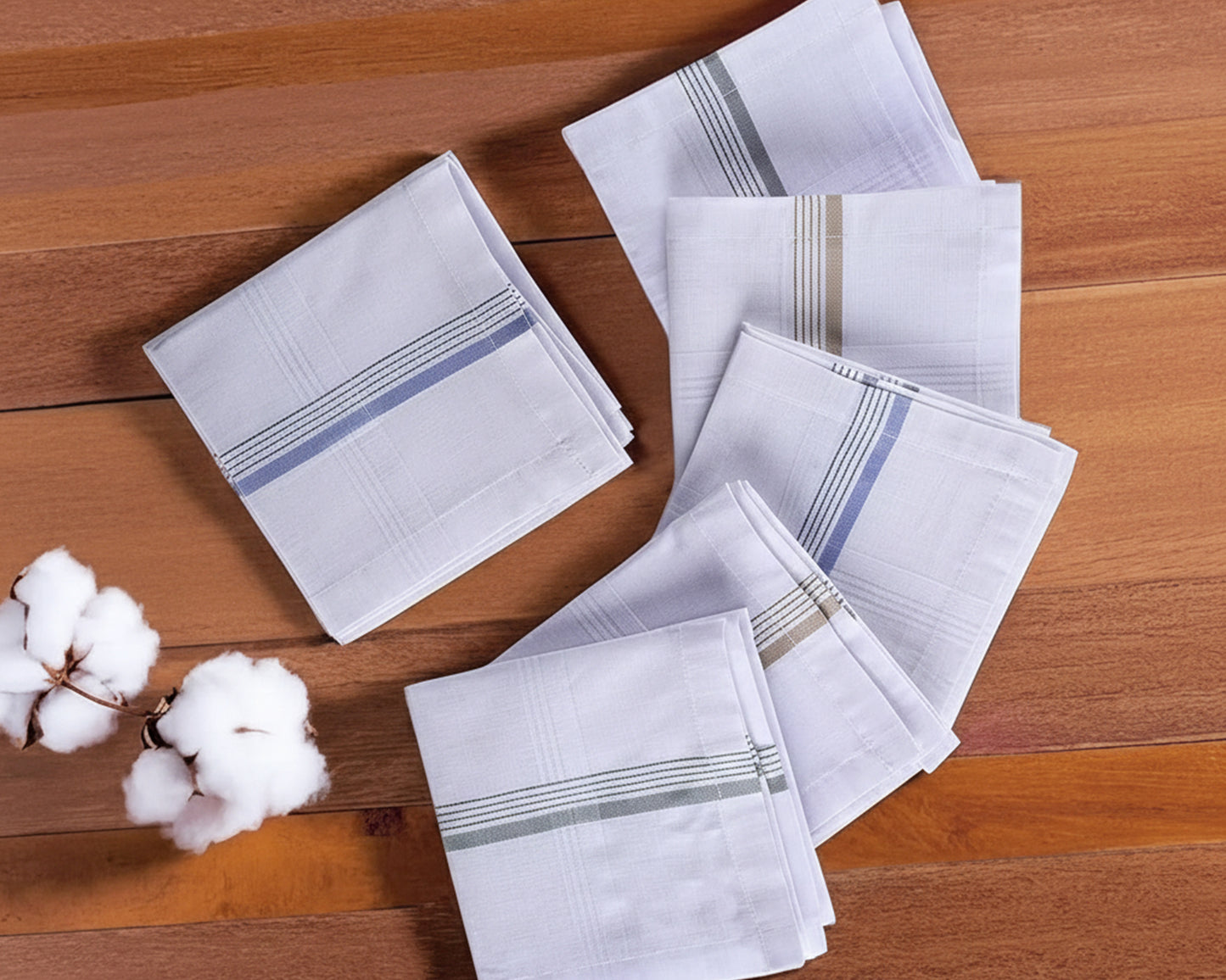 Set of white handkerchiefs with gray stripes on a wooden surface, accompanied by cotton buds.