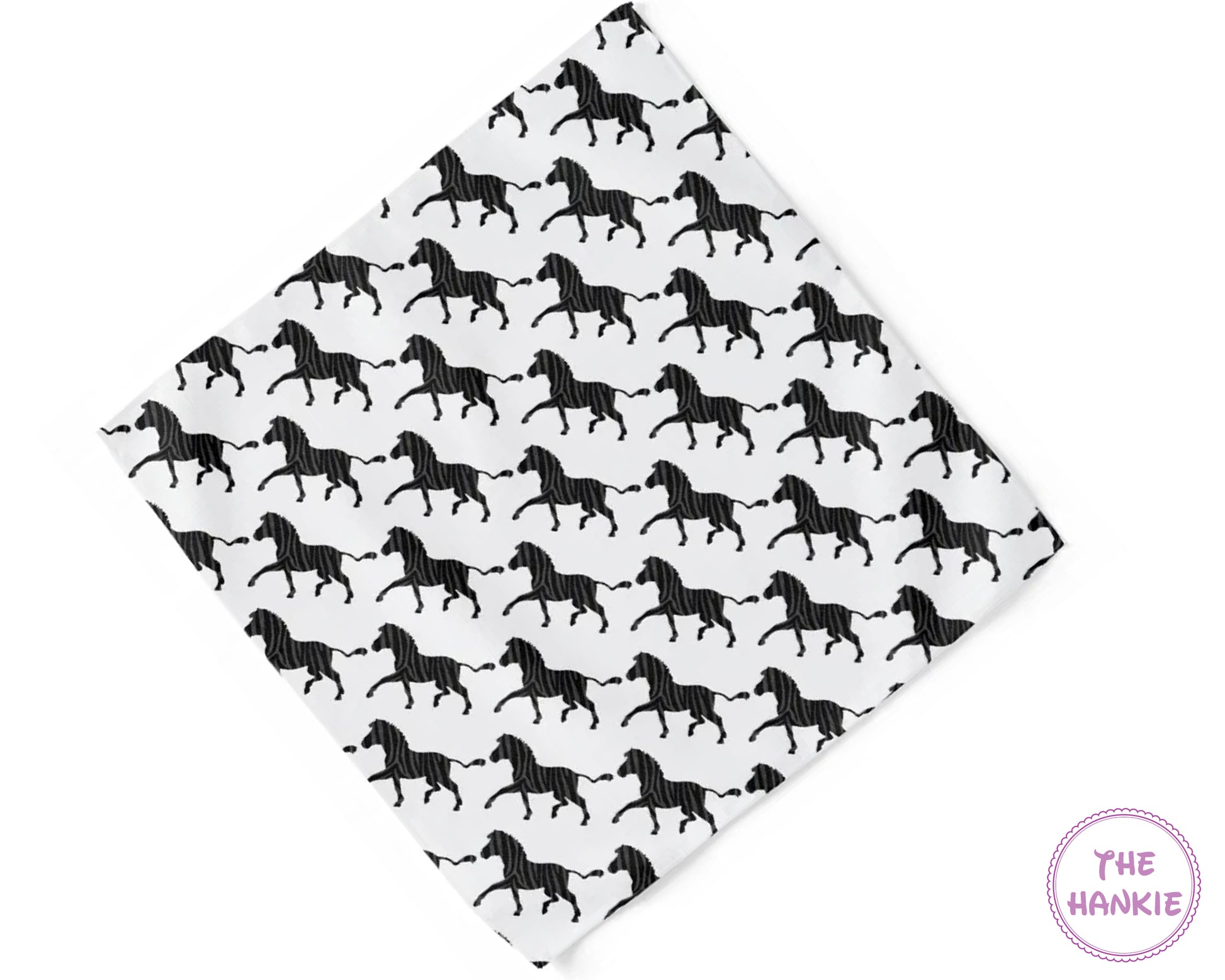 Folded fabric with black horse pattern on white background, branded 'The Hankie'.