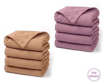 Stacks of folded brown and purple blankets on a white background with 'The Hankie' logo.