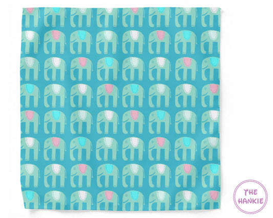 Patterned towel with elephant design on a blue background, featuring the brand 'The Hankie'.