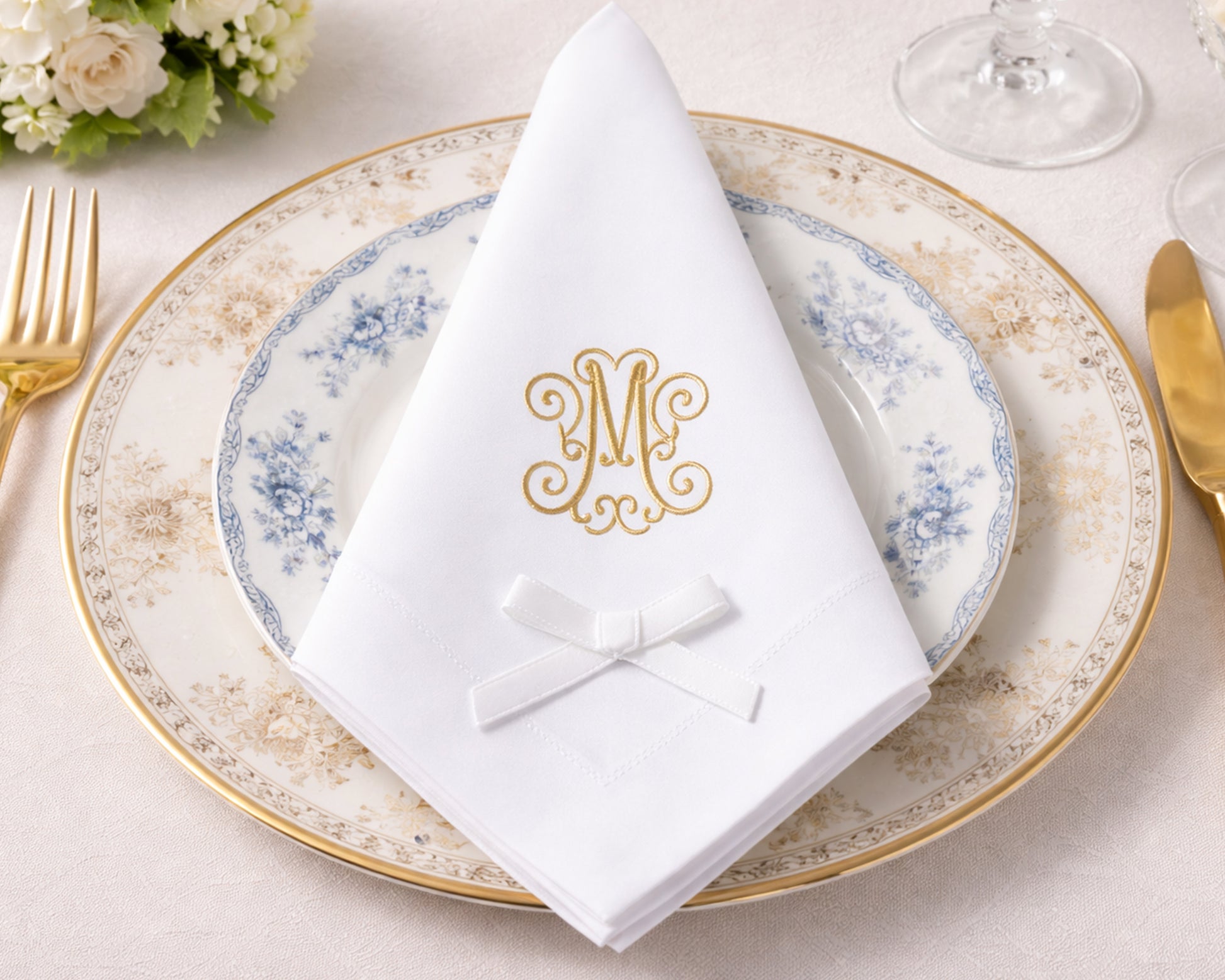 Elegant table setting with a decorative plate, napkin, and cutlery on a light background.