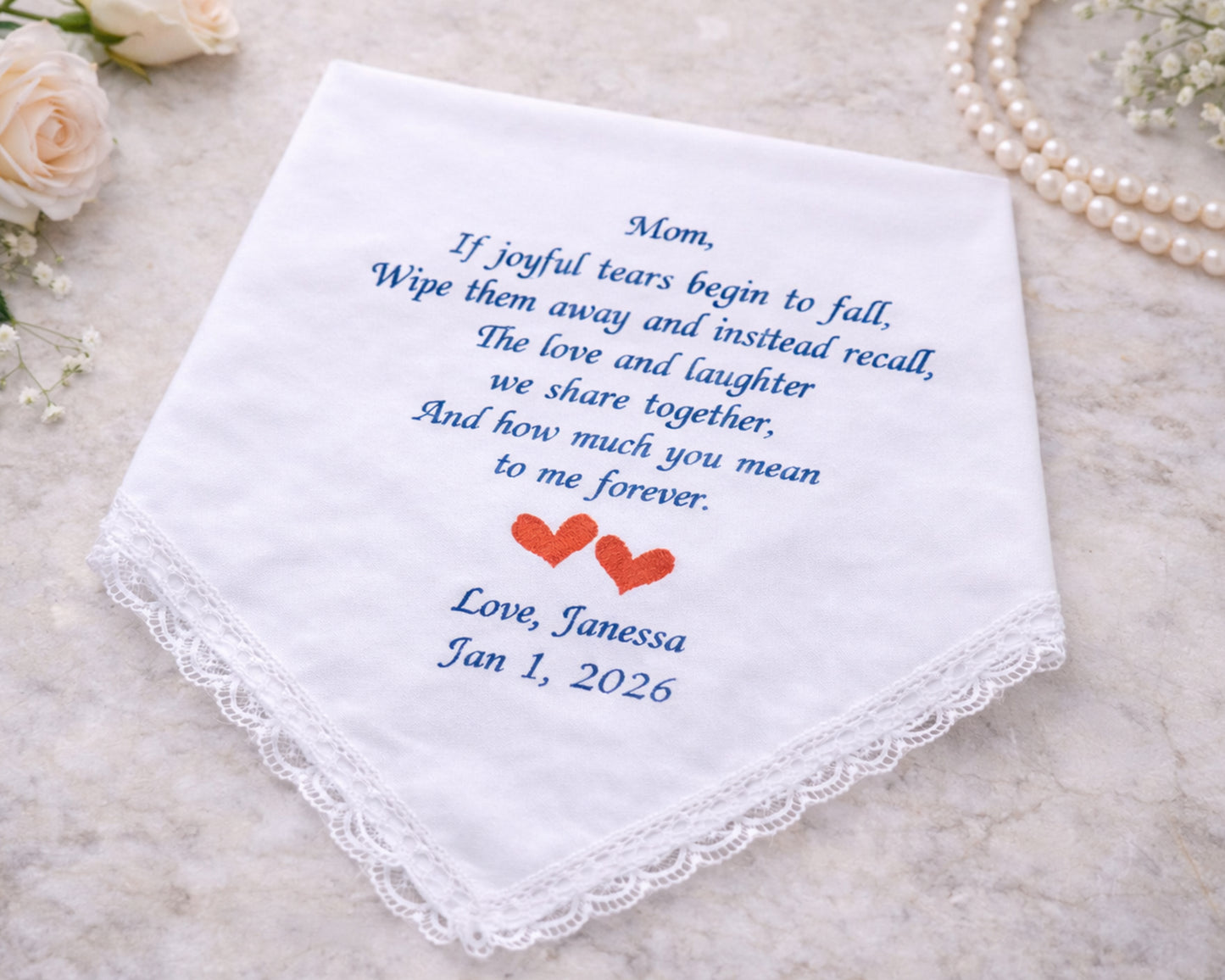 Embroidered handkerchief with a message and dates on a light background