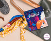 Disney Frozen-themed hankie on a handbag with colorful scarf and hat in the background