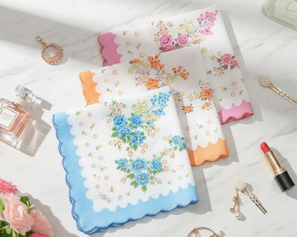 Set of floral handkerchiefs on a white surface with cosmetic items.