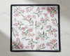 Floral patterned fabric square handkerchiefs on a light background