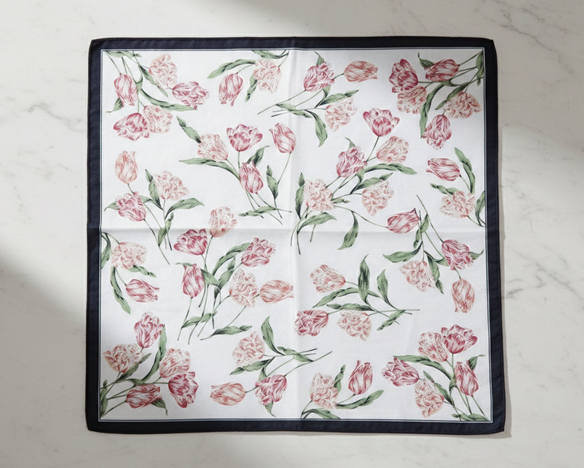 Floral patterned fabric square handkerchiefs on a light background