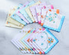 Set of floral handkerchiefs in various colors on a light background