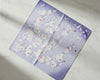 Floral patterned fabric square hankie on a light marble background