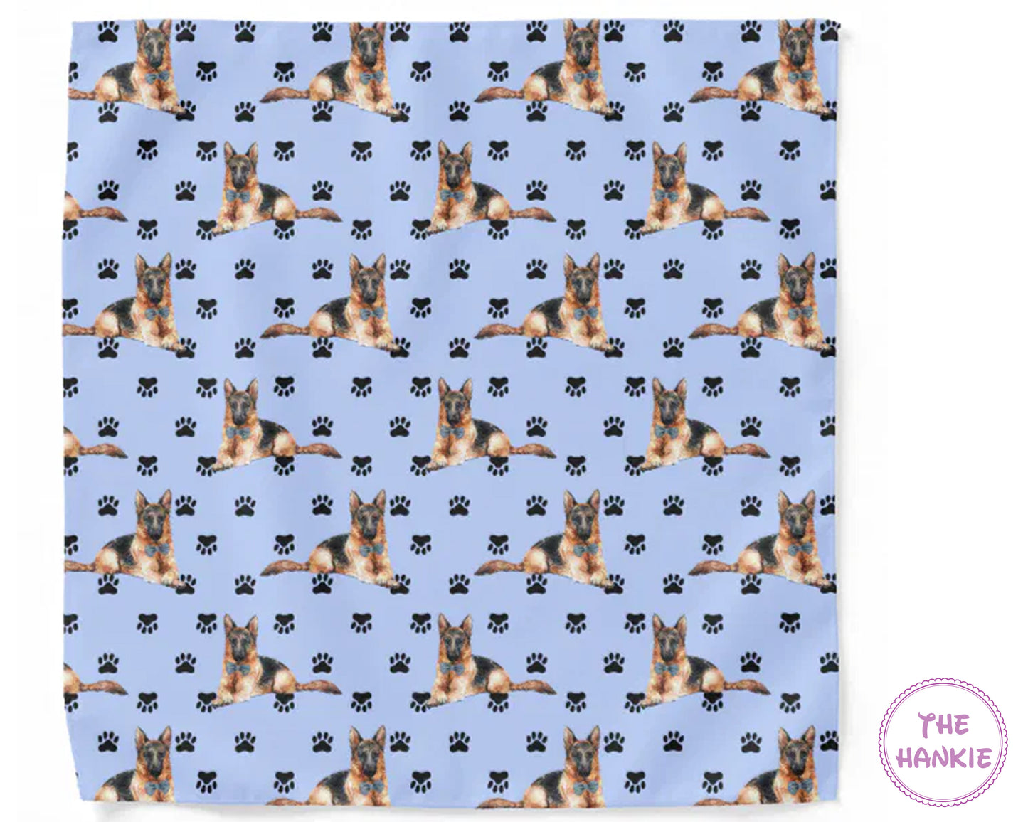 Patterned fabric with German Shepherd dogs and paw prints on a blue background, branded 'The Hankie'.