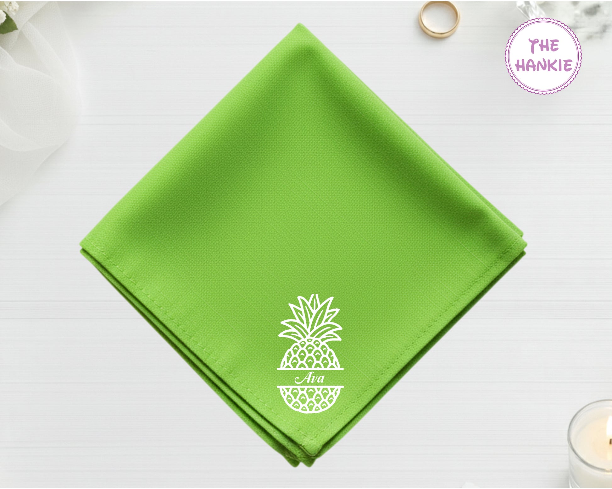 Green hanky with a white pineapple design on a light gray background