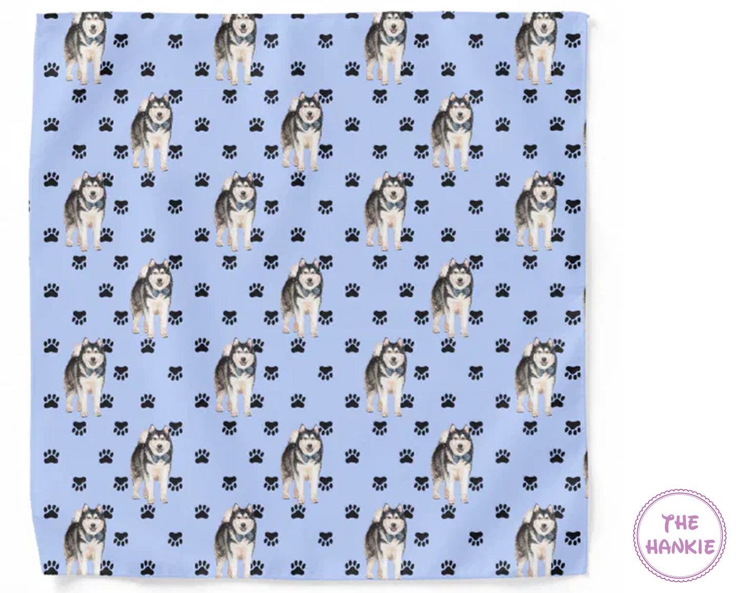 Patterned towel with husky dogs and paw prints on a blue background, branded 'The Hankie'.