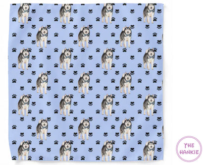 Patterned towel with husky dogs and paw prints on a blue background, branded 'The Hankie'.