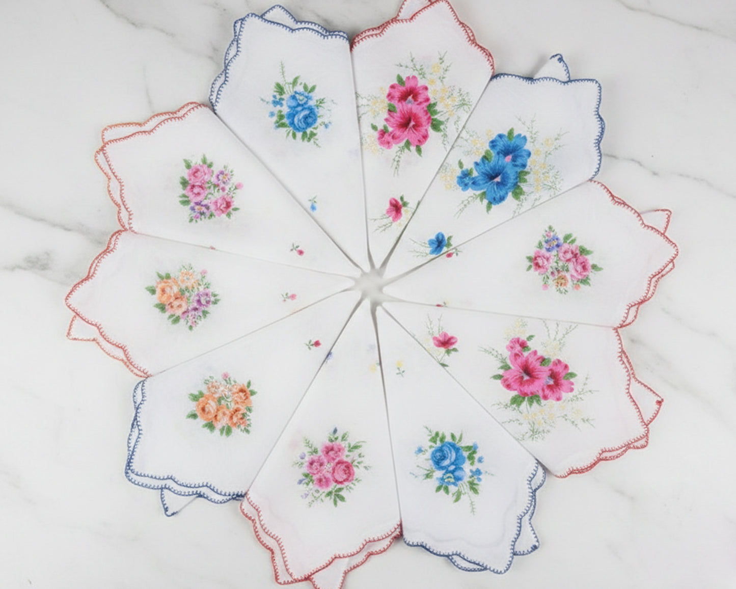 Set of embroidered handkerchiefs with floral patterns on a white background