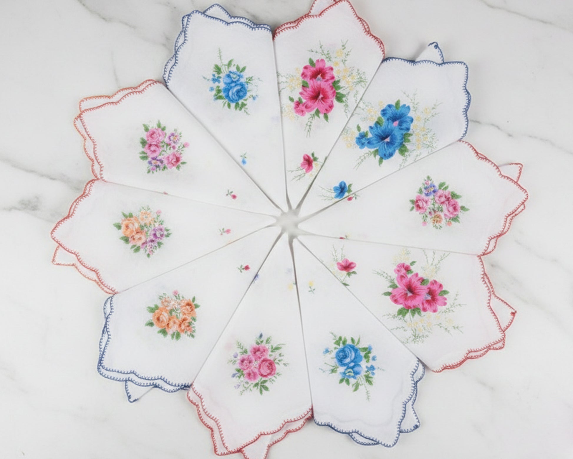 Set of embroidered handkerchiefs with floral patterns on a white background