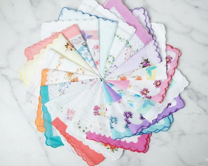 Set of colorful handkerchiefs with floral patterns arranged in a circular fashion on a marble surface.