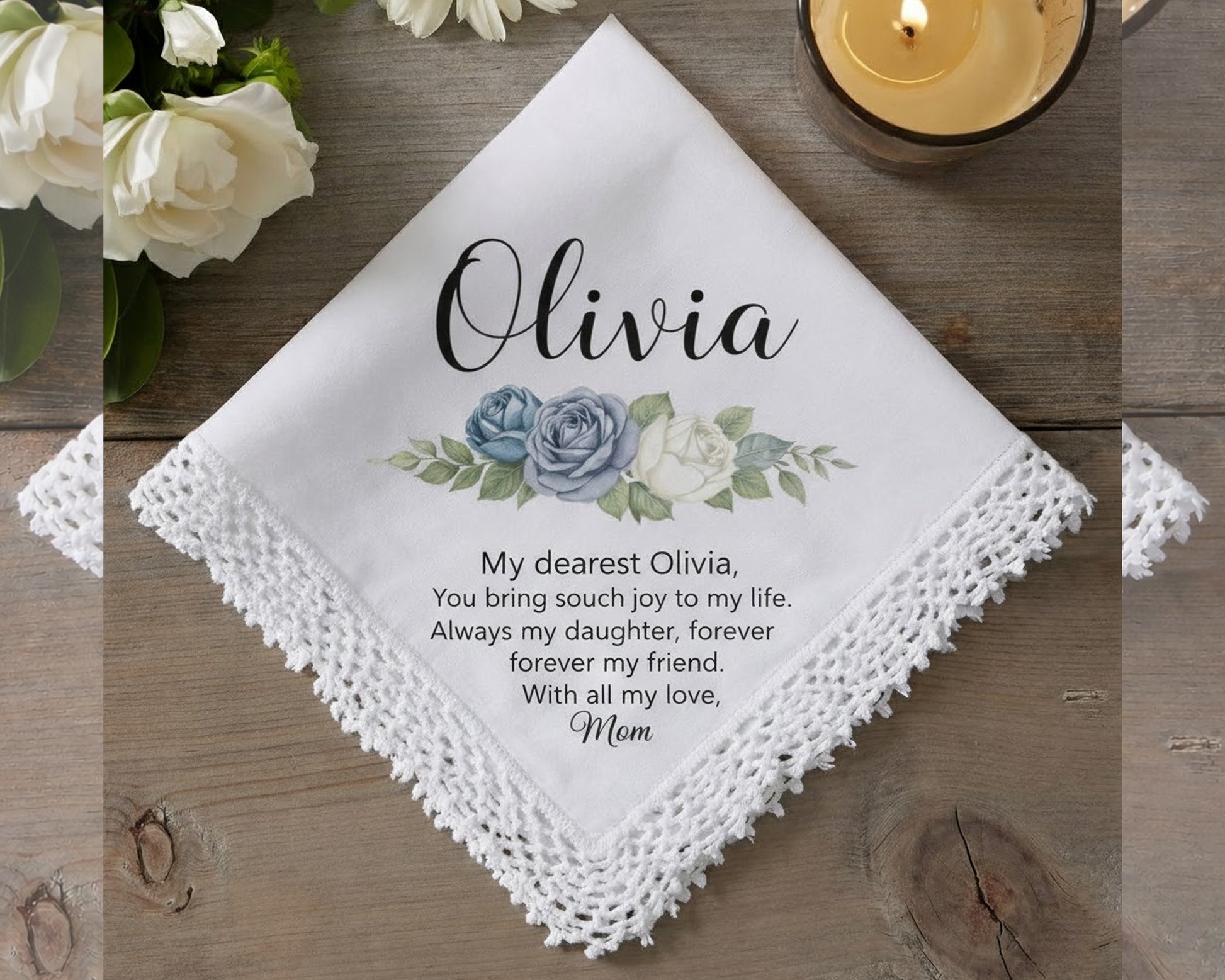 Personalized handkerchief with floral design and message on a wooden surface.