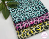 Three fabric hankies with leopard print patterns on a white surface, branded 'The Hankie'.