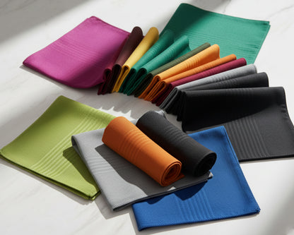 Set of colorful folded hankies on a white surface