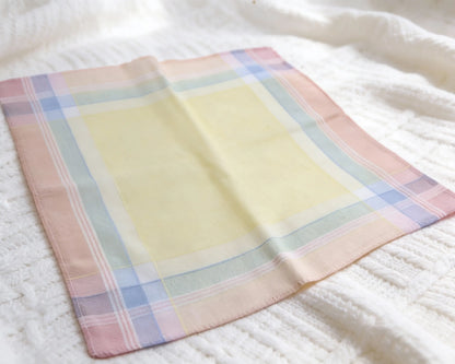 Pastel checkered hanky on a white textured surface