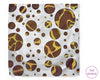 Patterned hankie with brown and yellow circles on a white background, branded 'The Hankie'.