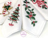 Set of white hankies with Christmas-themed designs including trees, holly, and candy canes.