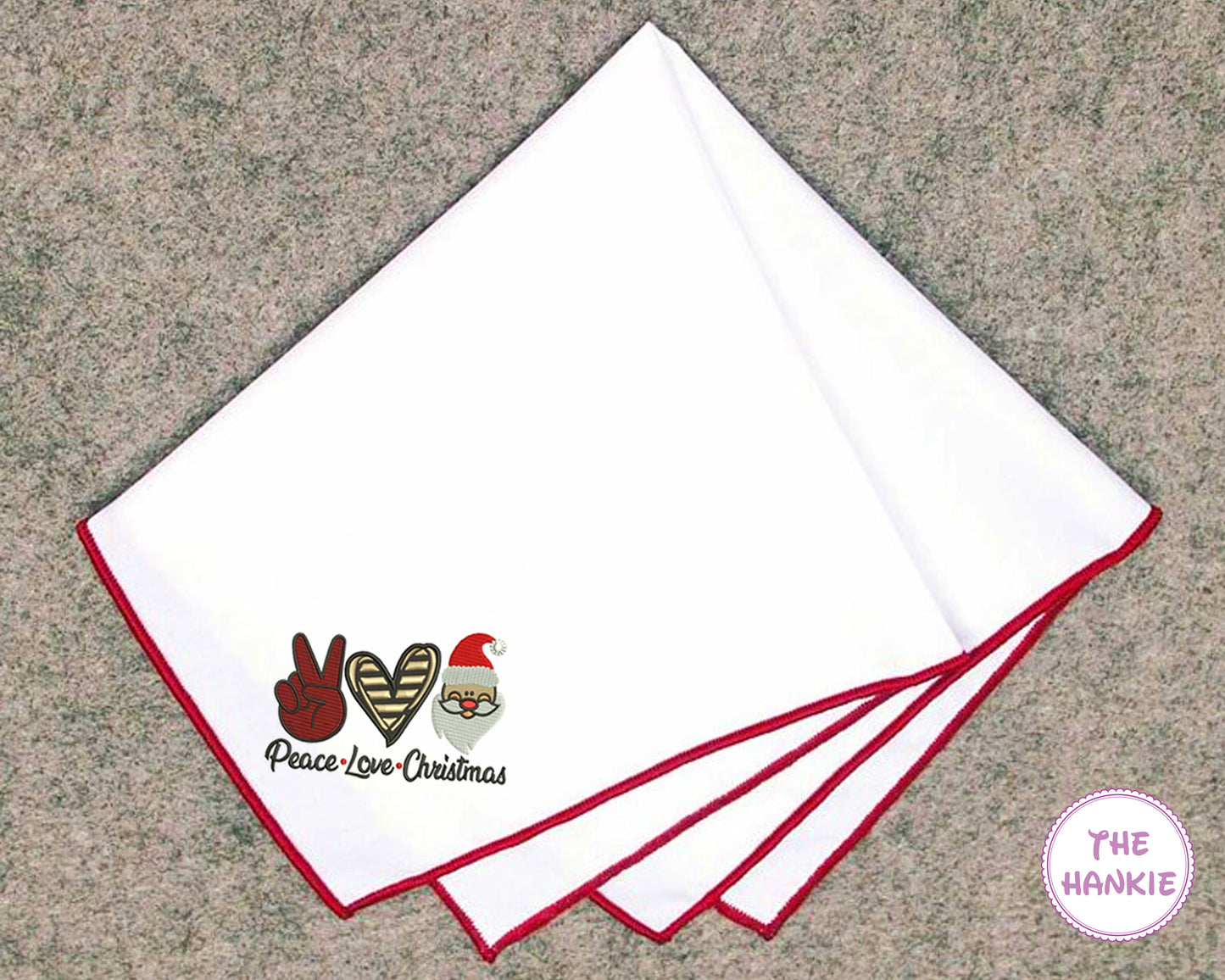 Set of white hankies with red trim featuring embroidered designs on a textured surface.