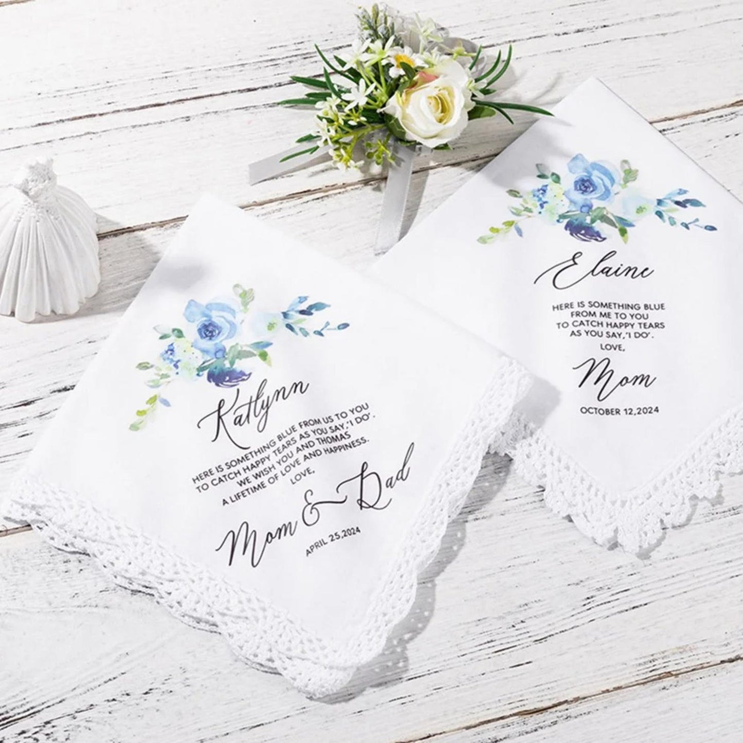 Two personalized handkerchiefs with floral designs and text on a wooden surface.
