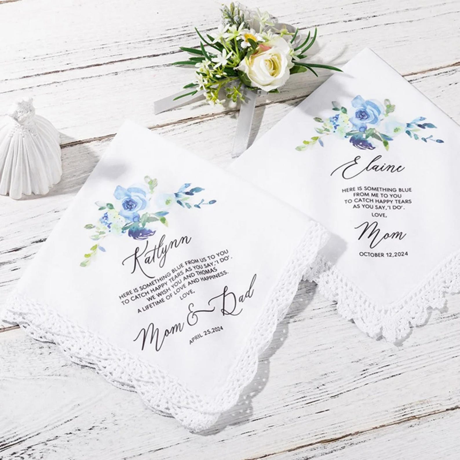 Two personalized handkerchiefs with floral designs and text on a wooden surface.