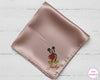 Pink satin square with embroidered character and 'Jacky' text on a light wooden surface, branded 'The Hankie'.