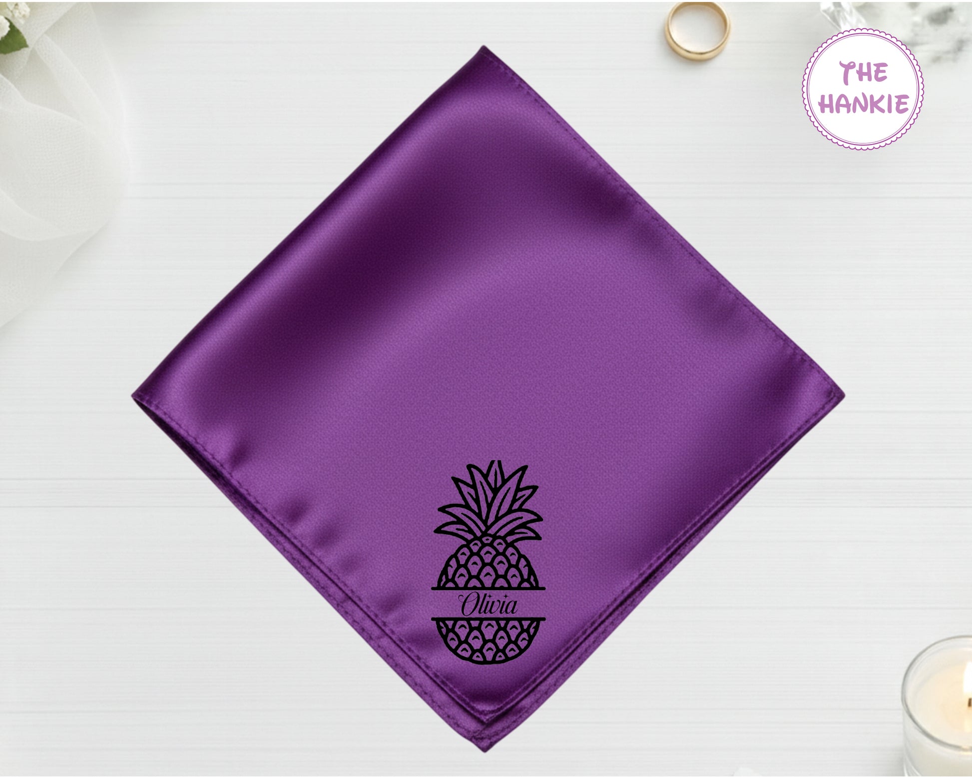 Purple satin pocket square with a pineapple design and 'Olica' text on a white background.