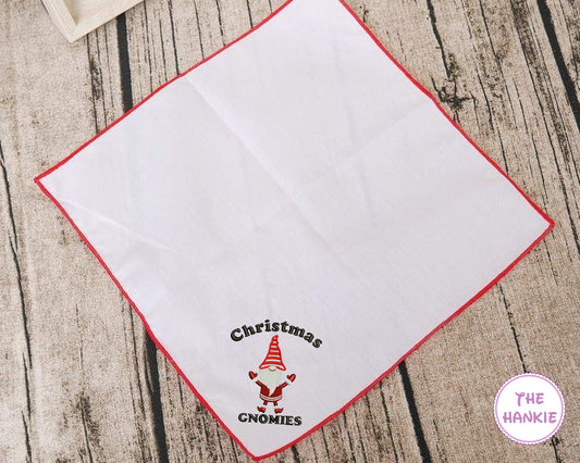 White hankie with embroidered red bell and green holly design, featuring 'The Hankie' brand.