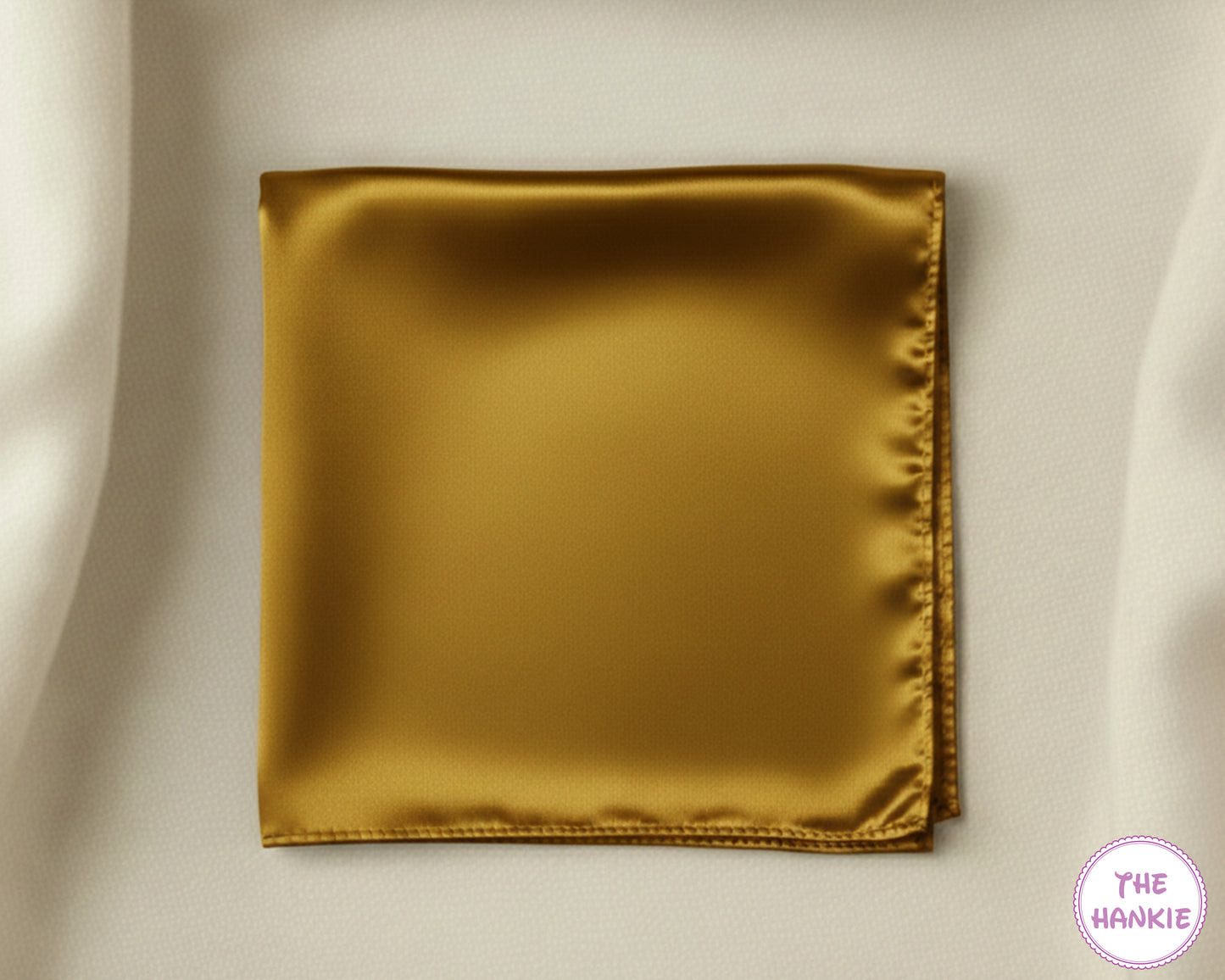 Gold satin hankie on a beige background with 'The Hankie' brand logo.