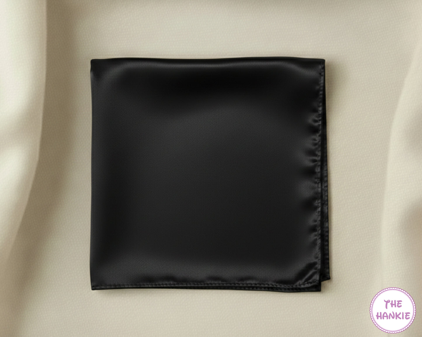 Black satin hankie on a beige background with 'The Hankie' brand logo.