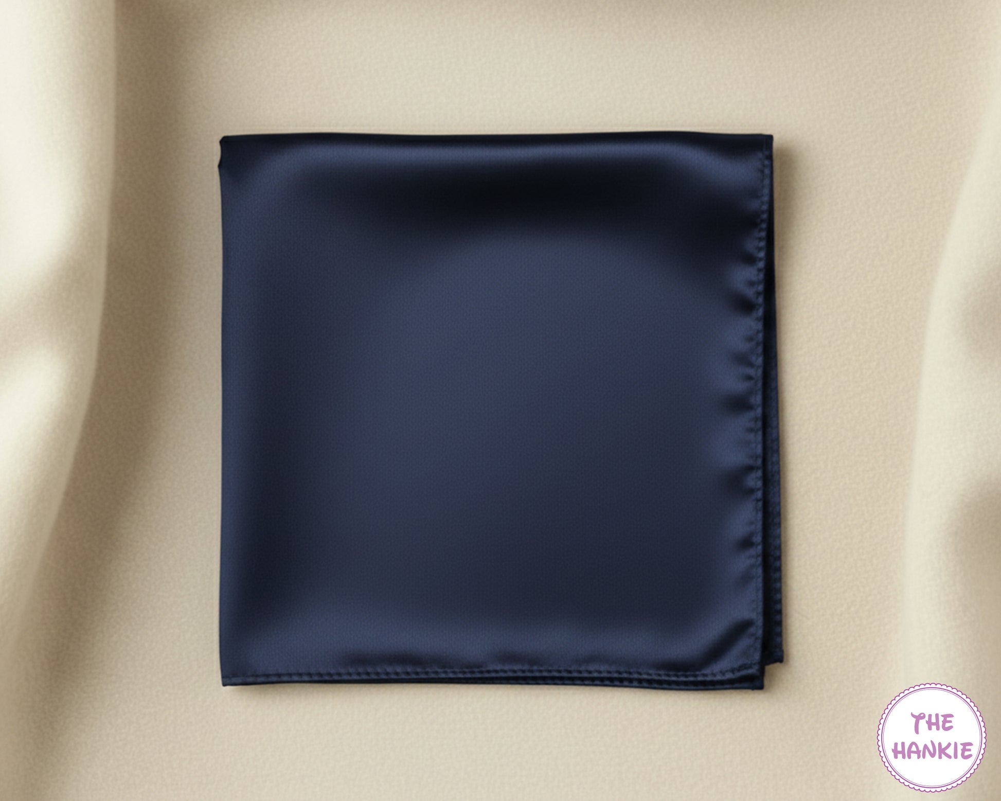 Navy blue satin hankie on a beige background with 'The Hankie' brand logo.