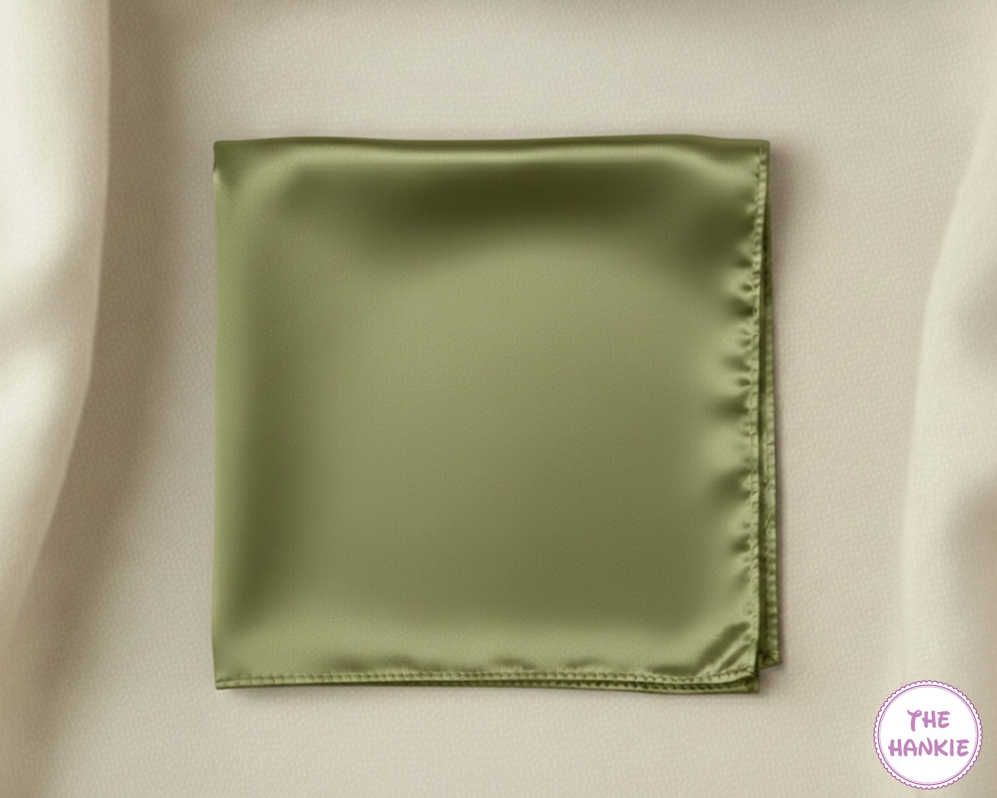 Green satin hankie on a beige background with 'The Hankie' logo.