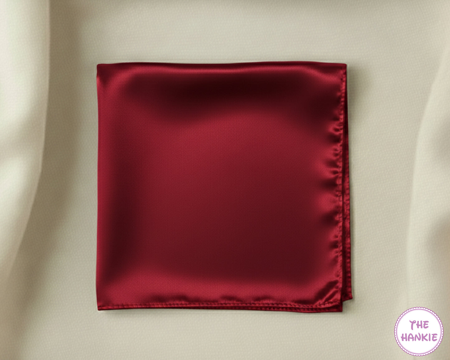 Red satin hankie on a beige background with 'The Hankie' logo.