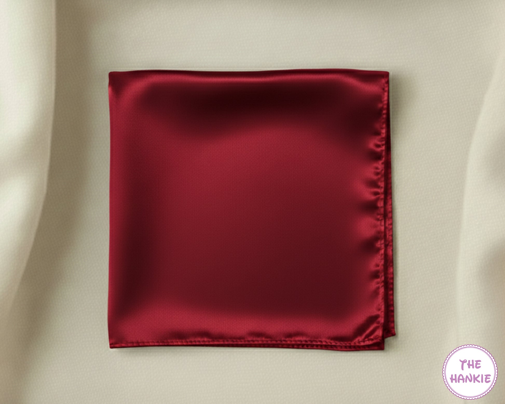 Red satin hankie on a beige background with 'The Hankie' logo.